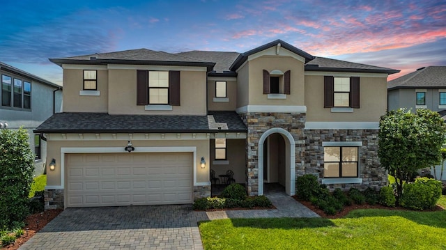 view of front of home featuring a garage and a lawn