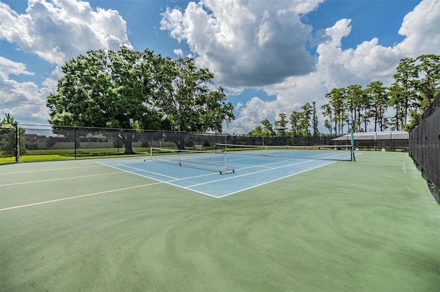 view of sport court featuring fence