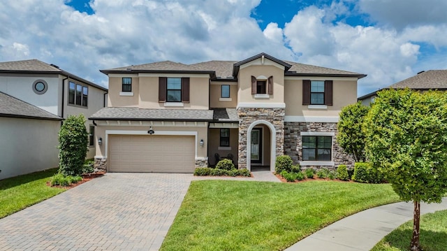 view of front of home with a garage and a front lawn