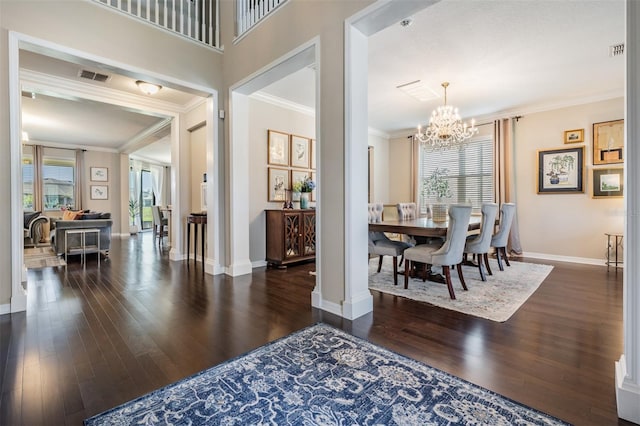 foyer entrance featuring visible vents, a healthy amount of sunlight, crown molding, and wood finished floors