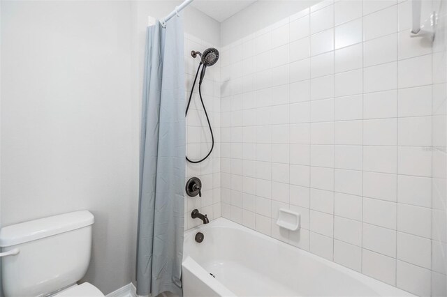 bathroom featuring toilet and shower / tub combo