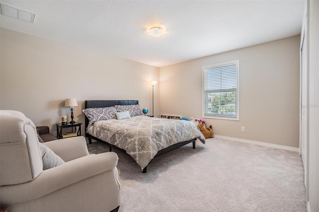 carpeted bedroom with visible vents and baseboards