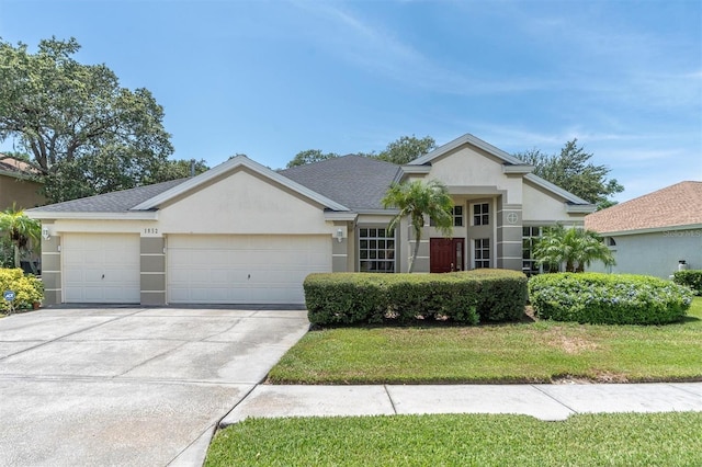 view of front of house featuring a garage and a front yard