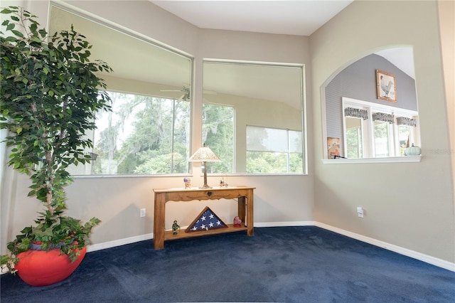 carpeted empty room featuring ceiling fan