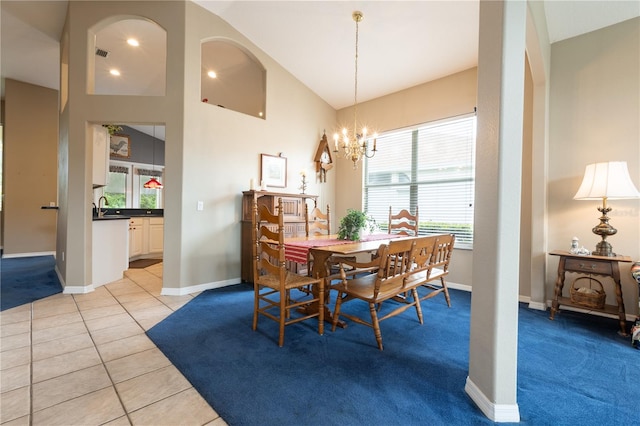 dining space with light tile patterned flooring, lofted ceiling, a notable chandelier, and plenty of natural light