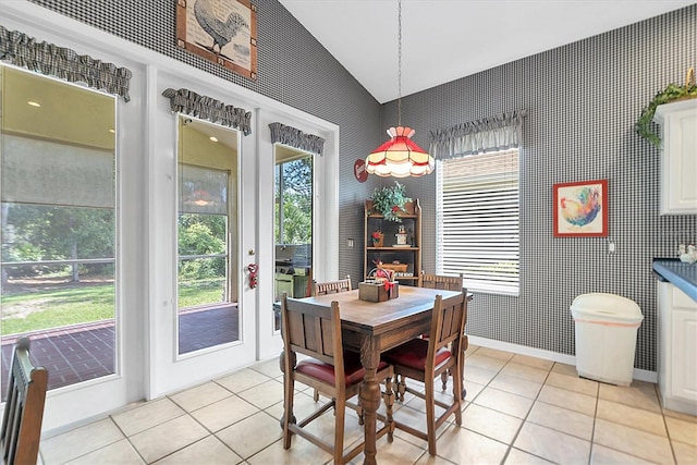 tiled dining room with vaulted ceiling