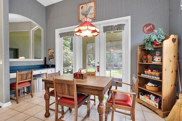 dining area featuring light tile patterned flooring and a wealth of natural light