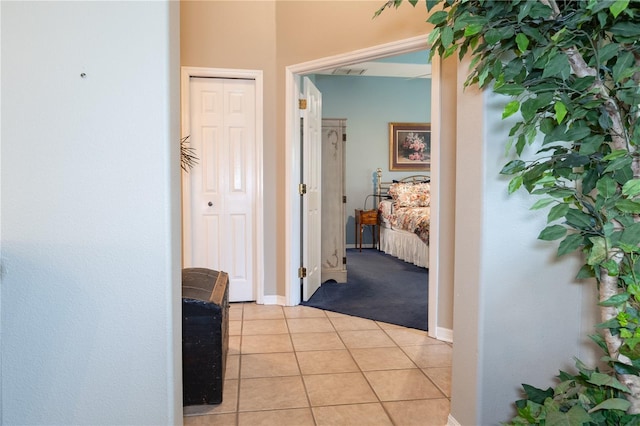 hall featuring light tile patterned floors