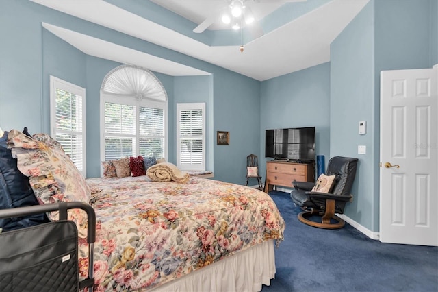 bedroom featuring ceiling fan, a raised ceiling, and carpet flooring