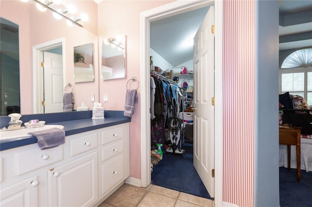 bathroom with vanity, tile patterned flooring, and vaulted ceiling