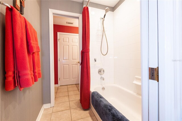 bathroom with tile patterned floors and shower / tub combo with curtain