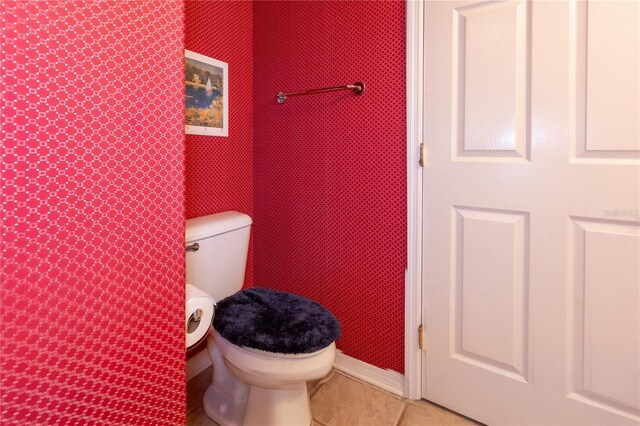 bathroom with toilet and tile patterned floors