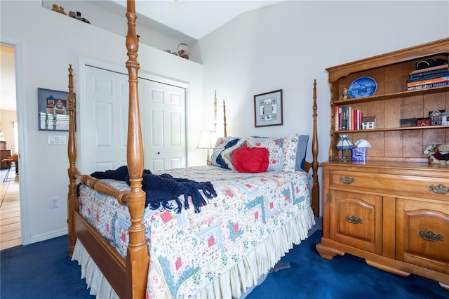 bedroom with carpet, a closet, and vaulted ceiling