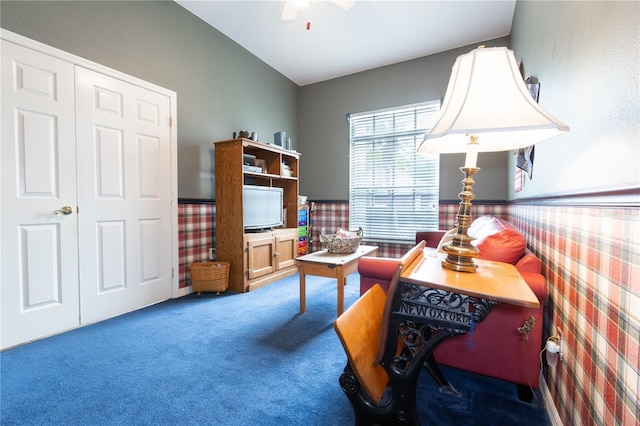 sitting room with ceiling fan and carpet flooring