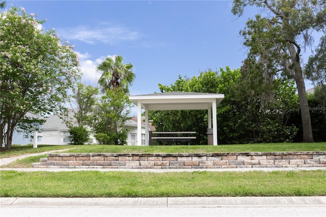 view of property's community featuring a garage and a lawn