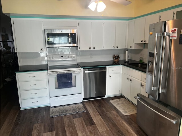 kitchen featuring tasteful backsplash, white cabinets, ceiling fan, dark hardwood / wood-style floors, and appliances with stainless steel finishes