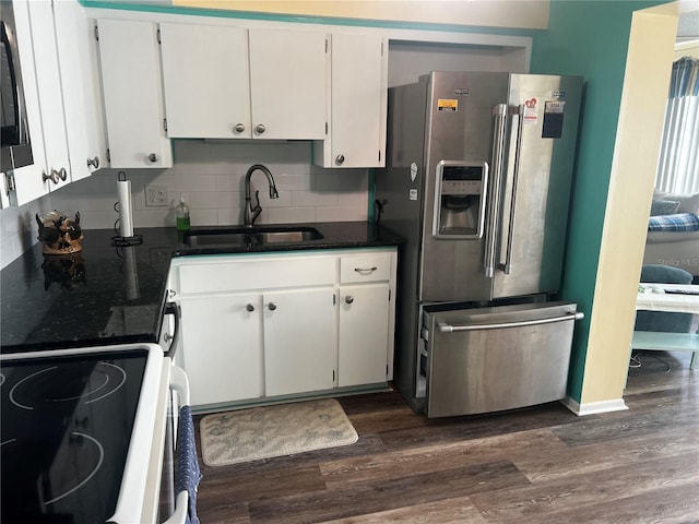 kitchen featuring white cabinets, stainless steel fridge, sink, decorative backsplash, and dark wood-type flooring