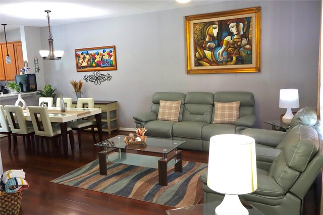 living room featuring dark hardwood / wood-style flooring and a chandelier