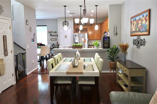 dining space with an inviting chandelier and dark wood-type flooring