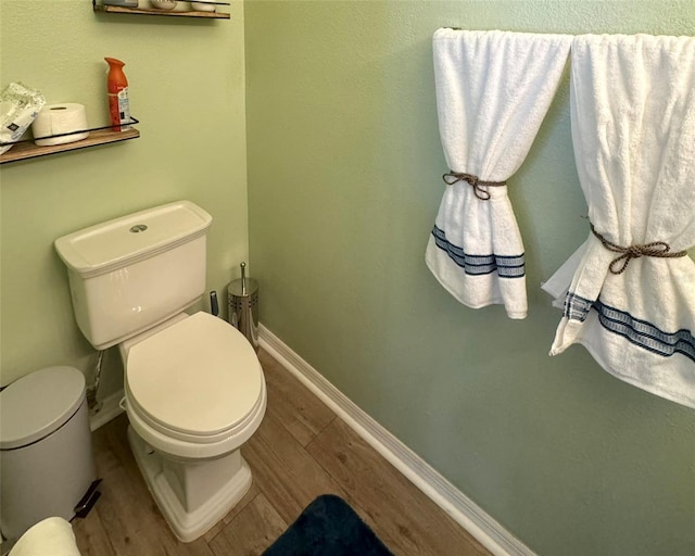 bathroom with toilet and hardwood / wood-style floors