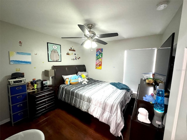 bedroom with dark hardwood / wood-style floors and ceiling fan