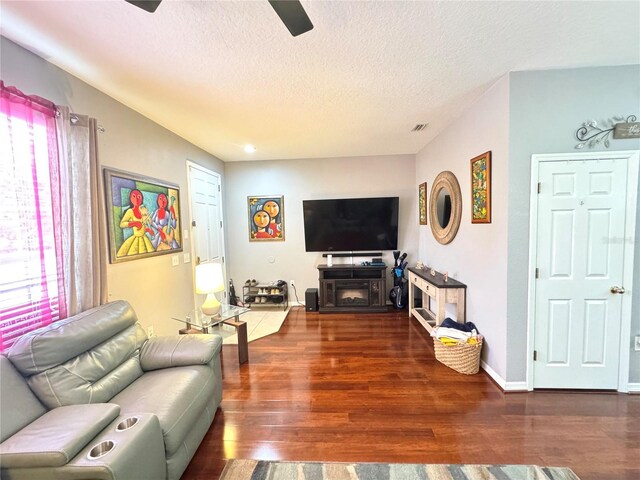 6546 Marlberry Way, Largo, FL 33773 - living area featuring a ceiling fan, a textured ceiling, wood finished floors, and a wealth of natural light