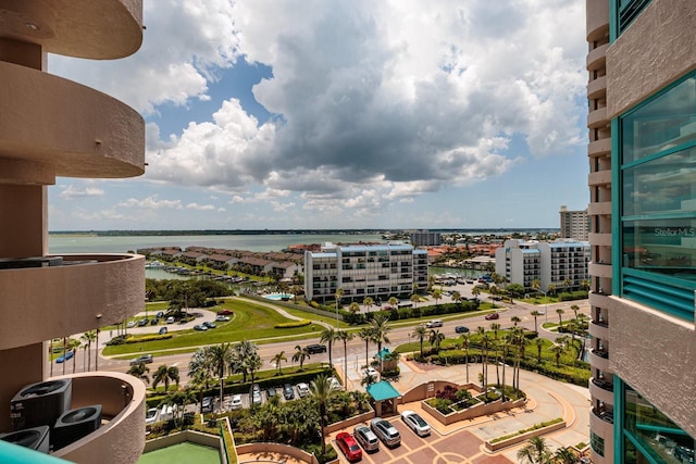 balcony featuring a water view and a view of city