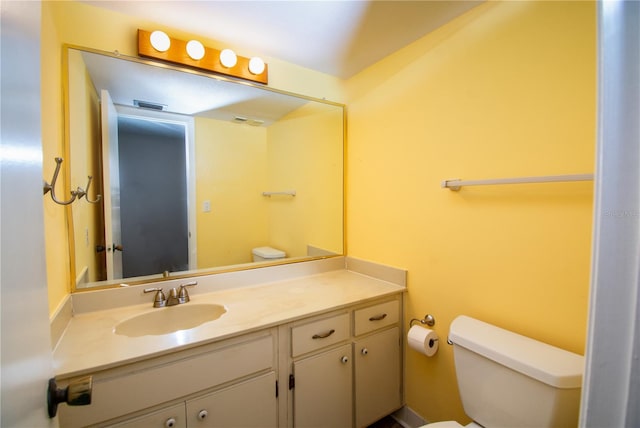 bathroom featuring toilet and vanity