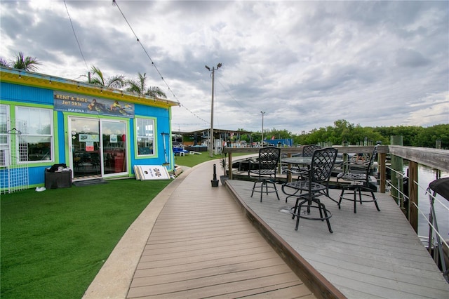 wooden deck featuring a lawn