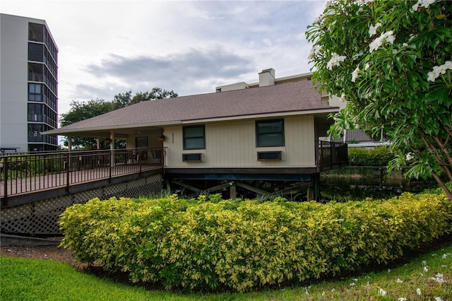 view of side of home featuring a wooden deck and cooling unit