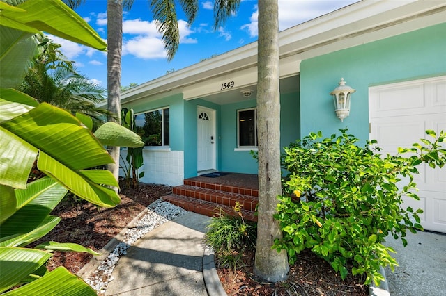 view of exterior entry with a garage