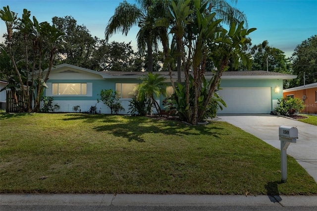 ranch-style home with a garage and a front yard