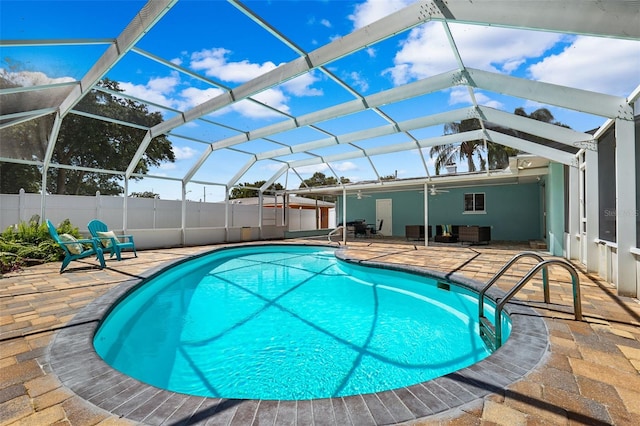 view of pool featuring a patio and glass enclosure