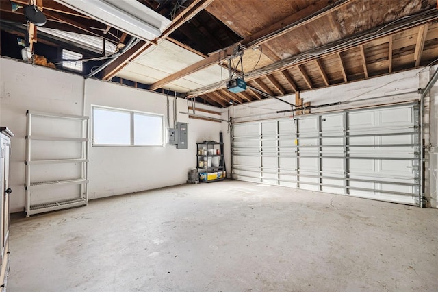 garage with a garage door opener and electric panel