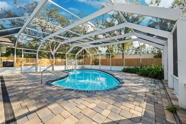 view of pool featuring a lanai and a patio