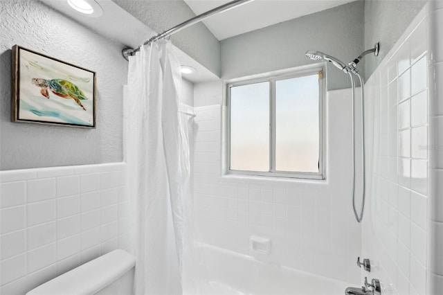 bathroom with toilet and shower / bathtub combination with curtain