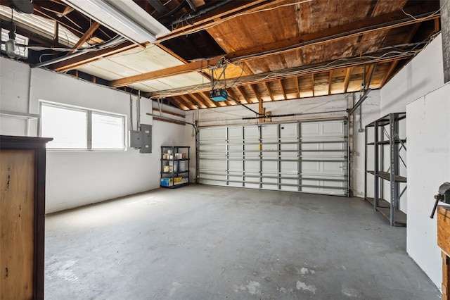 garage with a garage door opener and electric panel