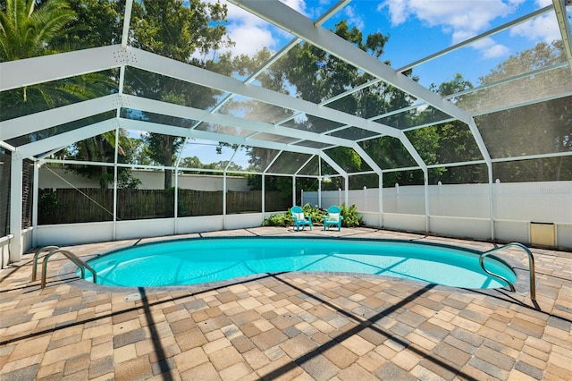 view of swimming pool with a patio and glass enclosure