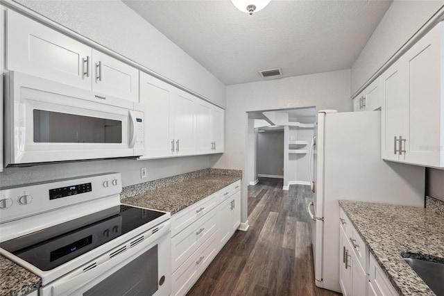 kitchen featuring stone countertops, white appliances, dark hardwood / wood-style floors, a textured ceiling, and white cabinets