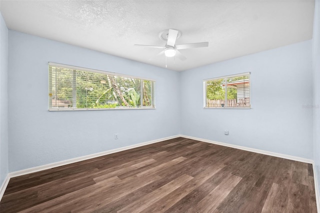 unfurnished room with ceiling fan, dark hardwood / wood-style floors, and a textured ceiling