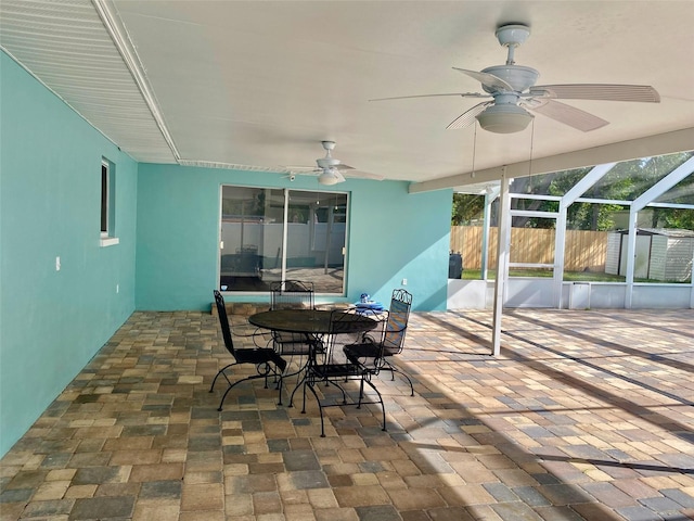 view of patio with ceiling fan and a storage unit