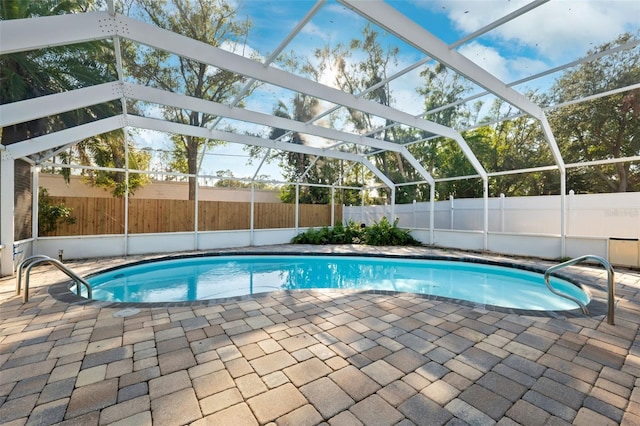 view of swimming pool with a lanai and a patio area