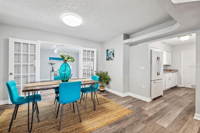 1549 Linwood Dr, Clearwater, FL 33755 - dining space with baseboards, a textured ceiling, wood finished floors, and ceiling fan