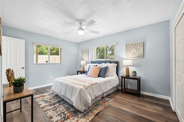 1549 Linwood Dr, Clearwater, FL 33755 - bedroom with multiple windows, a textured ceiling, baseboards, and dark wood-style floors