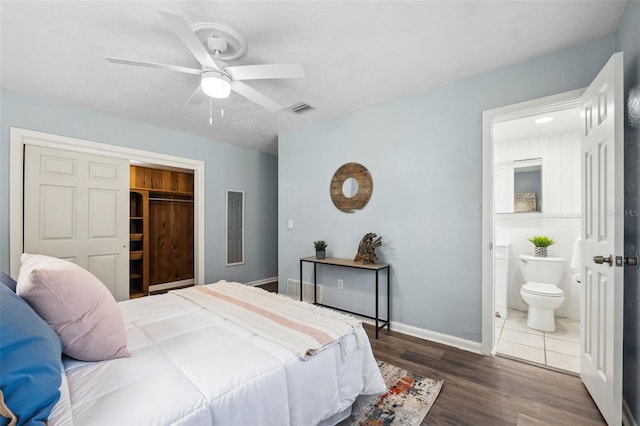 1549 Linwood Dr, Clearwater, FL 33755 - bedroom with wood finished floors, baseboards, a closet, ensuite bath, and ceiling fan