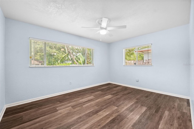 1549 Linwood Dr, Clearwater, FL 33755 - empty room featuring healthy amount of natural light, dark wood-style flooring, a ceiling fan, and a textured ceiling