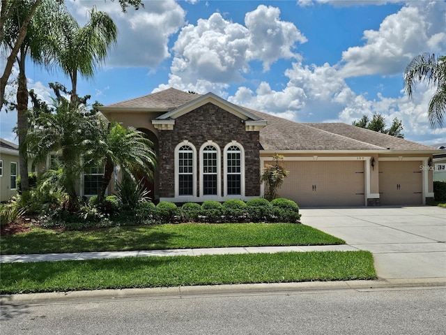 view of front of property with a garage and a front lawn