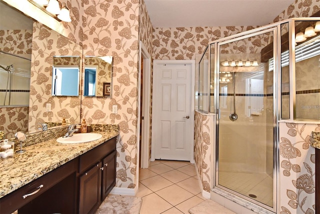 bathroom featuring tile patterned flooring, vanity, and a shower with door