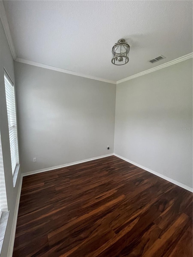 unfurnished room featuring crown molding, dark hardwood / wood-style floors, and a textured ceiling