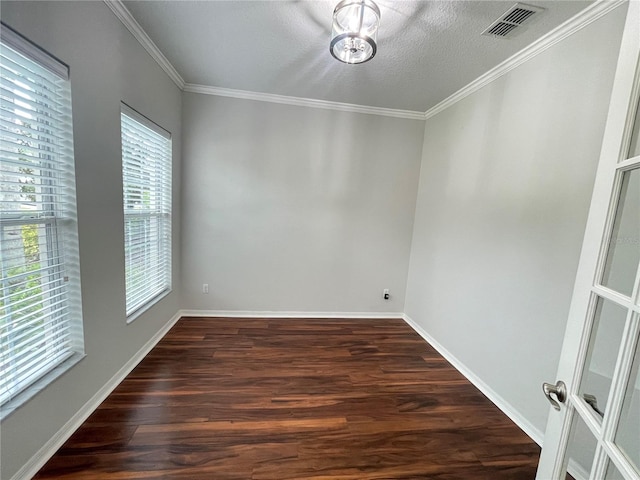 unfurnished room with ornamental molding, dark hardwood / wood-style floors, and a textured ceiling